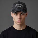 A man wearing a black vintage-wash cotton Anointed Garments baseball cap with white embroidered logo text.