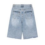Anointed Garments vintage washed denim shorts in light blue with a wide-leg silhouette, back pockets, and raw hem.