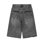 Anointed Garments vintage washed black denim shorts with a wide-leg silhouette, raw hem, and back pocket detail.