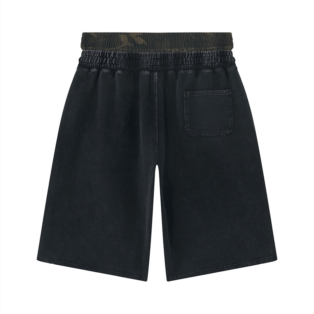 Anointed Garments washed-black cotton shorts with an elastic waistband, rear patch pocket, and relaxed fit.