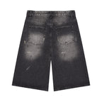 Anointed Garments wide leg denim shorts in washed black with distressed detailing and five-pocket styling, back view.