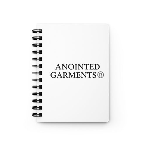 Anointed Garments white spiral bound journal with a glossy laminated cover and black metal coil binding.