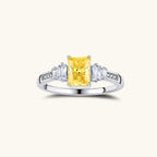 Anointed Garments platinum-plated sterling silver ring featuring a radiant yellow rectangular moissanite center stone.