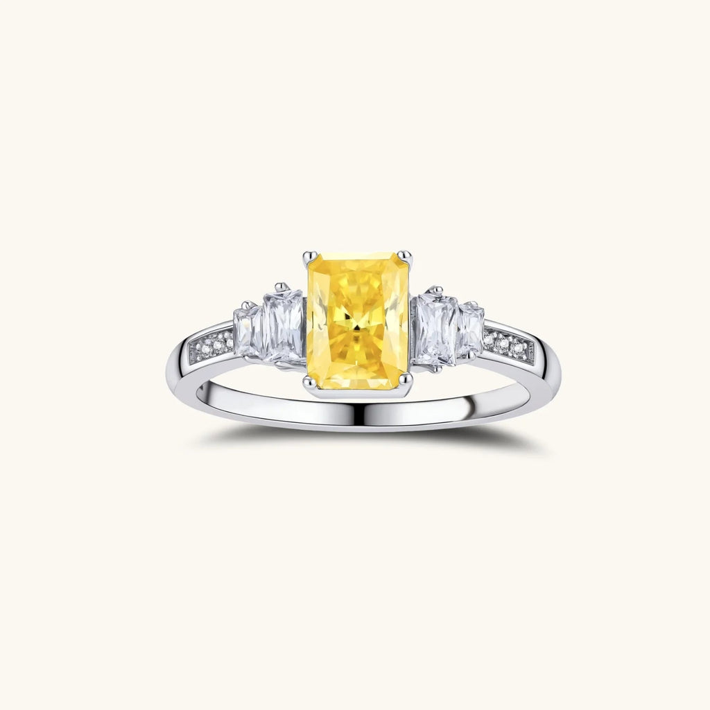 Anointed Garments Sunset Sovereign three-stone ring with a yellow moissanite center in platinum-plated sterling silver.
