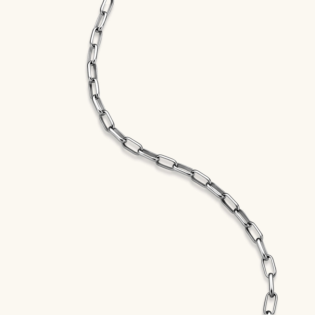Polished 925 sterling silver paperclip link chain necklace, 3.7mm wide, with lobster clasp, on cream background.