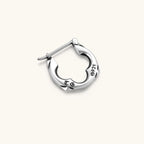 Polished 925 sterling silver quatrefoil hoop earrings with hinged snap closure and engraved hallmark, on cream background.