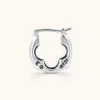 Polished 925 sterling silver quatrefoil hoop earrings with hinged snap closure and engraved hallmark, on cream background.