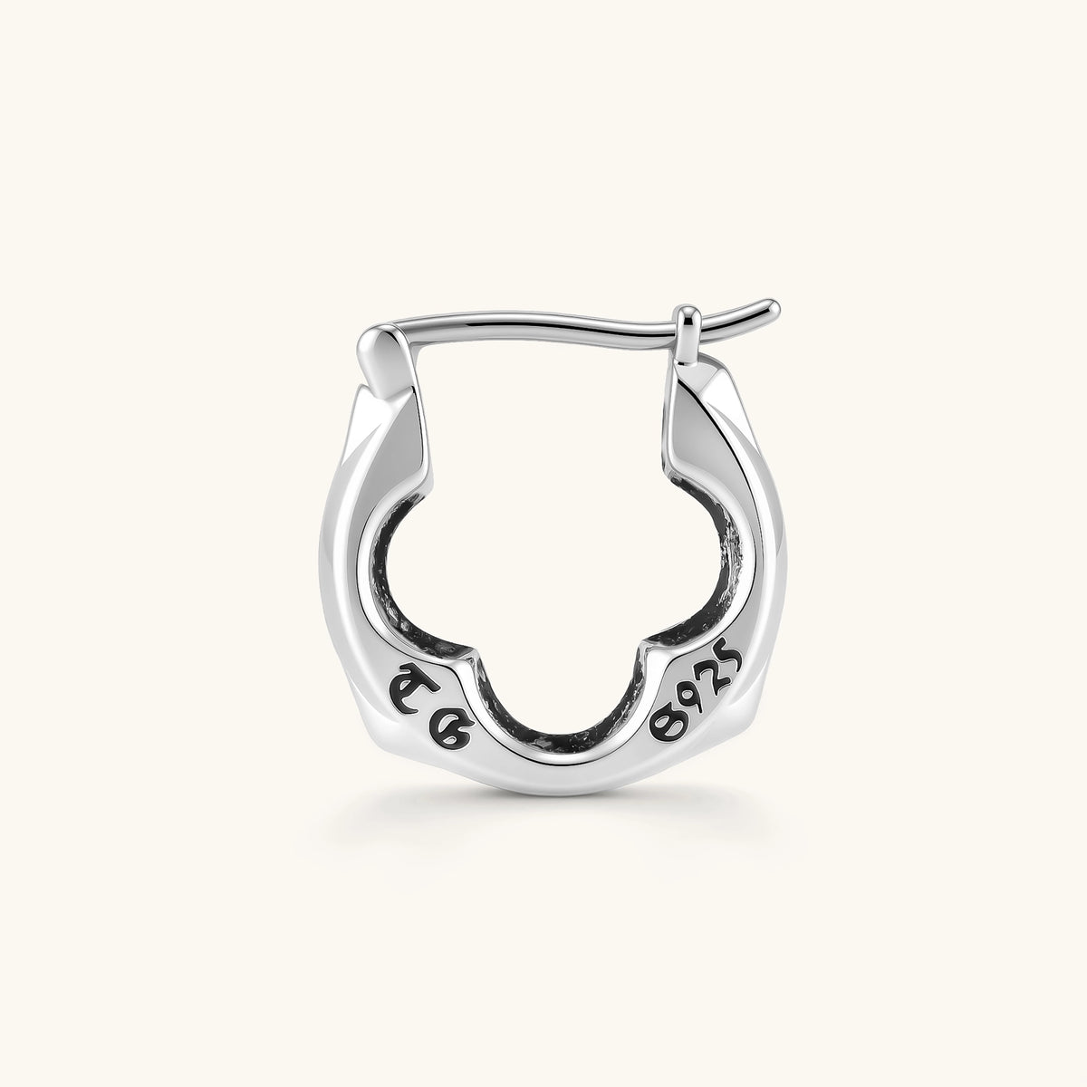 Polished 925 sterling silver quatrefoil hoop earrings with hinged snap closure and engraved hallmark, on cream background.