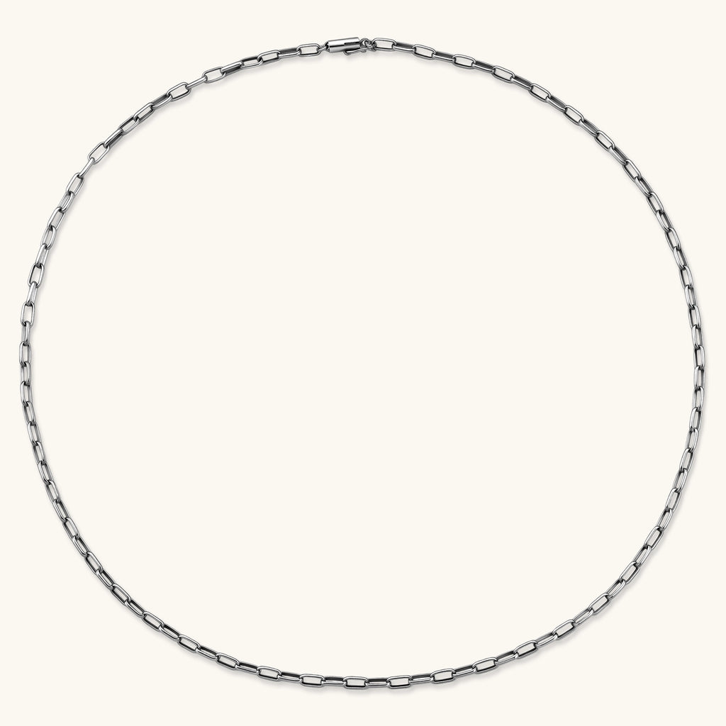 Polished 925 sterling silver paperclip link chain necklace, 3.7mm wide, with lobster clasp, on cream background.