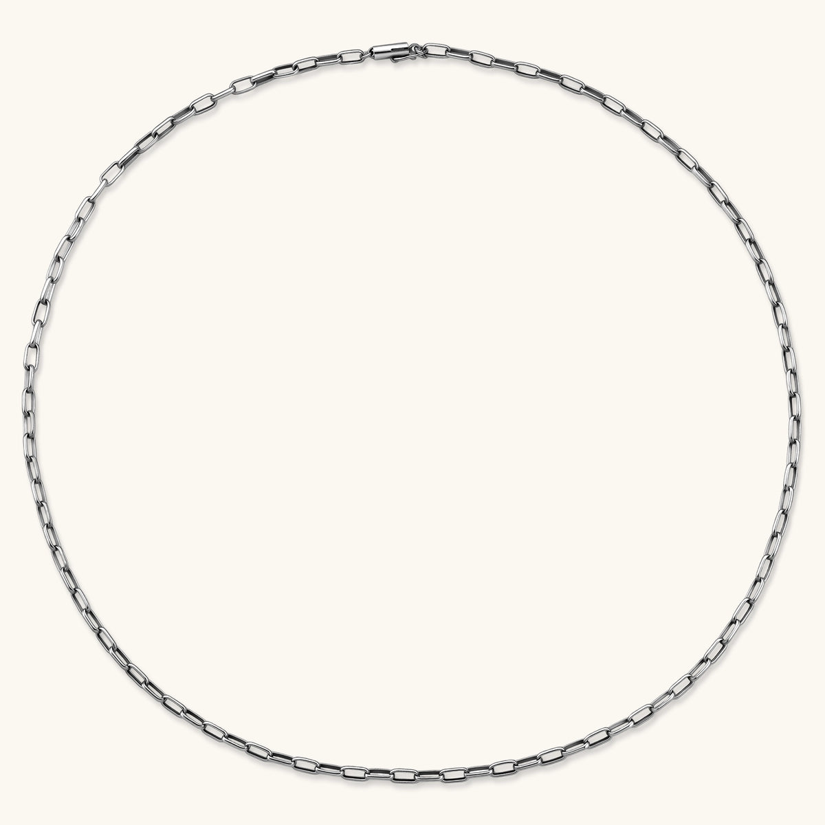 Polished 925 sterling silver paperclip link chain necklace, 3.7mm wide, with lobster clasp, on cream background.